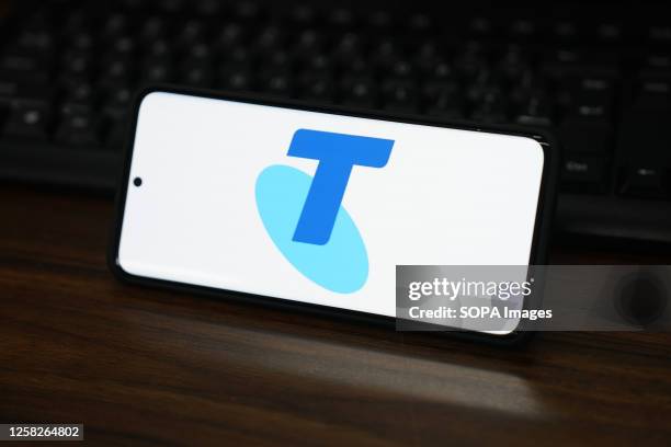 In this photo illustration, the Telstra logo is displayed on the screen of a smartphone.