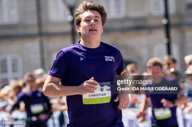 Denmark's Prince Christian arrives at the finish line at Amalienborg Castle Square after participating in a One Mile Family run during the Royal Run...