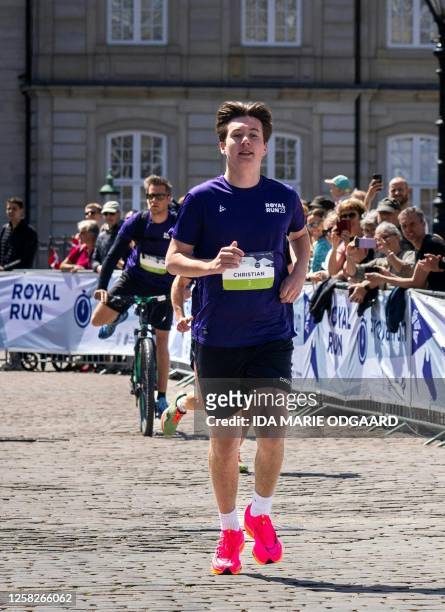 Denmark's Prince Christian arrives at the finish line at Amalienborg Castle Square after participating in a One Mile Family run during the Royal Run...