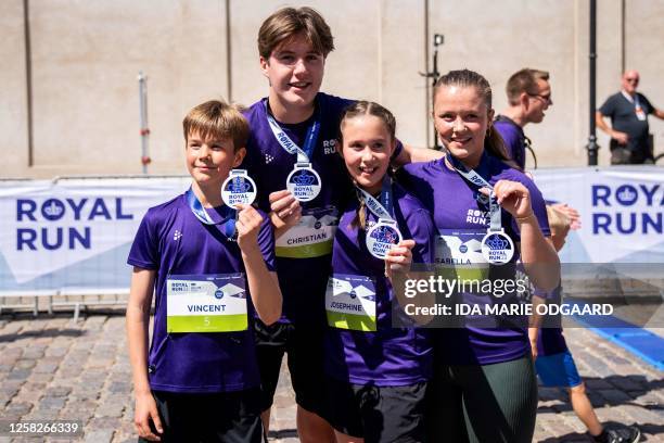 Denmark's Princess Josephine , Princess Isabella, Prince Christian and Prince Vincent pose after running a One Mile Family run during the Royal Run...