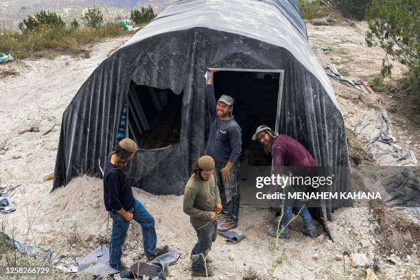Israeli settlers erect a tent at the outpost of Homesh in the occupied West Bank on May 29, 2023. Israeli settlers started reviving the flashpoint...