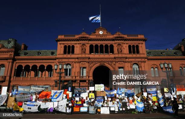 Flowers and posters hang on the railing around the Casa Rosada presidential palace in Buenos Aires following the death of former Argentine President...