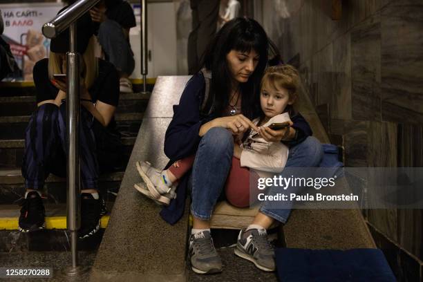 Nataliia holds her daughter Solomiya as they sit in the Kyiv metro underground station with other Kyiv residents as they shelter during the second...