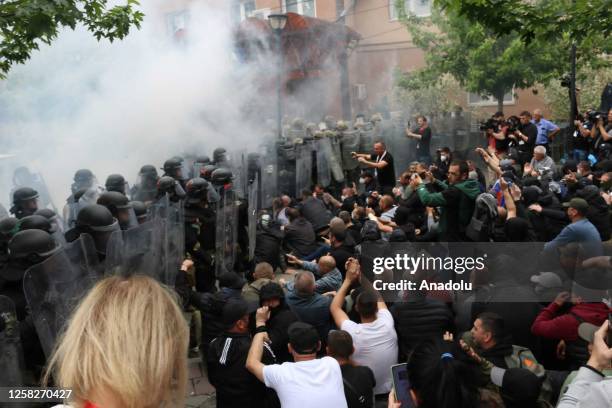 Kosovo riot police along with KFOR military police, secure access to a municipal building in Zvecan as Kosovo Serbs gather outside the building after...