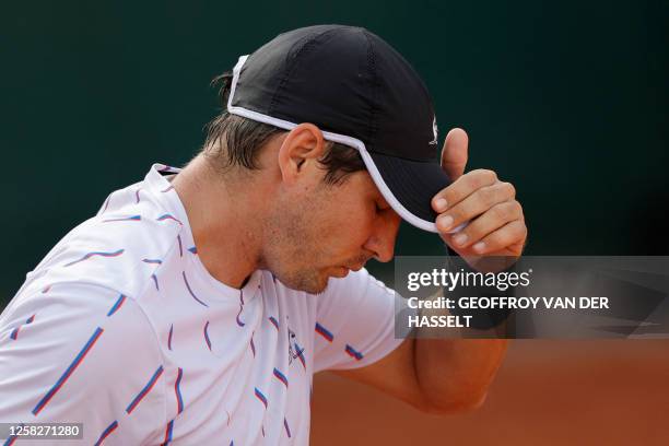 Serbia's Dusan Lajovic reacts before abandoning against China's Zhang Zhizhen during their men's singles match on day two of the Roland-Garros Open...