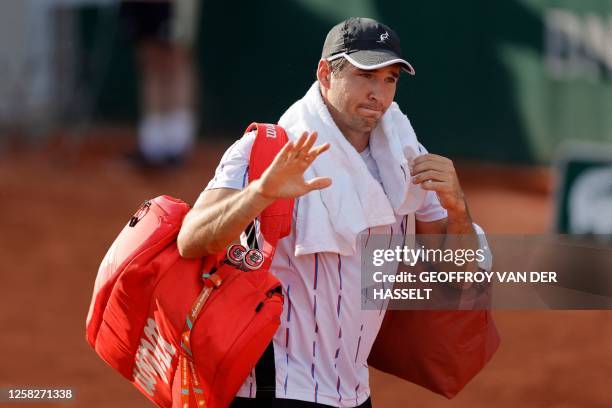 Serbia's Dusan Lajovic gestures as he gives up against China's Zhang Zhizhen during their men's singles match on day two of the Roland-Garros Open...