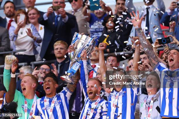 Barry Bannan of Sheffield Wednesday lifts the trophy with team mates during the Sky Bet League One Play-Off Final between Barnsley and Sheffield...