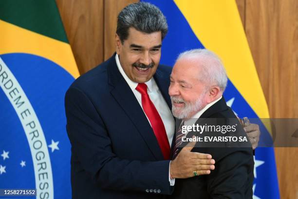 Venezuela's President Nicolas Maduro and Brazil's President Luiz Inacio Lula da Silva greet each other after a joint press conference at the Planalto...