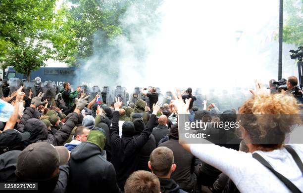 Serbs from Kosovo face riot police during their gathering to demand the removal of recently elected Albanian mayors outside municipal building in...