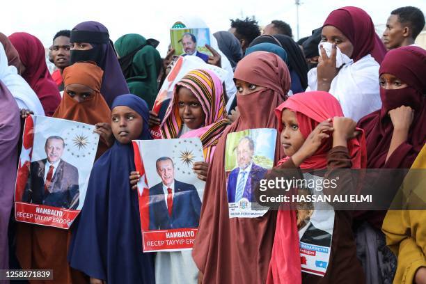 Somalis celebrate the victory of Turkish President Recep Tayyip Erdogan after he won the presidential run-off election during the celebration...