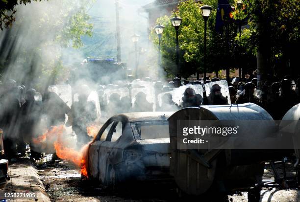 Kosovo riot police and KFOR military police, secure entrance to municipal building in Zvecan, northern Kosovo on May 29 following clashes with Serb...