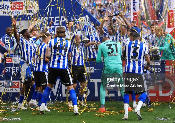 Barry Bannan of Sheffield Wednesday celebrates with the trophy among team mates after the Sky Bet League One Play-Off Final between Barnsley and...