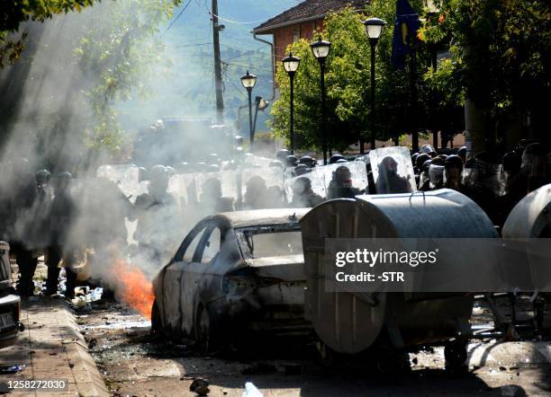 Kosovo riot police and KFOR military police, secure entrance to municipal building in Zvecan, northern Kosovo on May 29 following clashes with Serb...