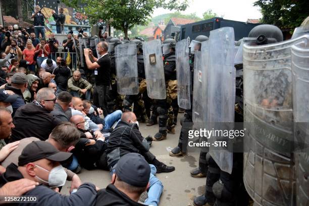 Serbs from Kosovo face riot police during their gathering to demand the removal of recently elected Albanian mayors outside municipal building in...