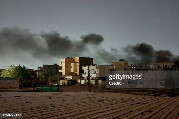 Smoke billows in southern Khartoum on May 29 amid ongoing fighting between two rival generals in Sudan. A one-week ceasefire aiming to allow...