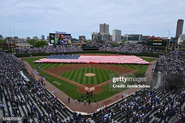 Giant U.S. Flag is displayed on the outfield during the U.S. National Anthem before a game between the Chicago Cubs and the Tampa Bay Rays at Wrigley...