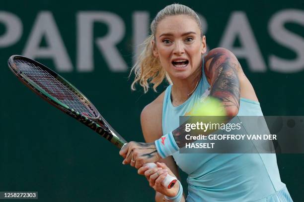 Czech Republic's Tereza Martincova plays a backhand return to Latvia's Jelena Ostapenko during their women's singles match on day two of the...