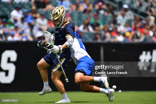 Jake Caputo of the Duke University Blue Devils strips Jack Simmons of the Notre Dame Fighting Irish of ball during the Division I Men's Lacrosse...