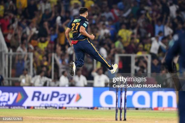 Gujarat Titans' Mohit Sharma celebrates after taking the wicket of Chennai Super Kings' captain Mahendra Singh Dhoni during the Indian Premier League...