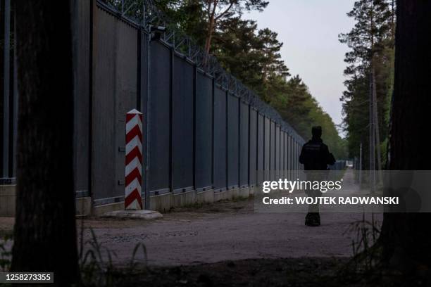 Border guard patrol along the border wall at Polish - Belarus border not far from Bialowieza, eastern Poland, on May 29, 2023.