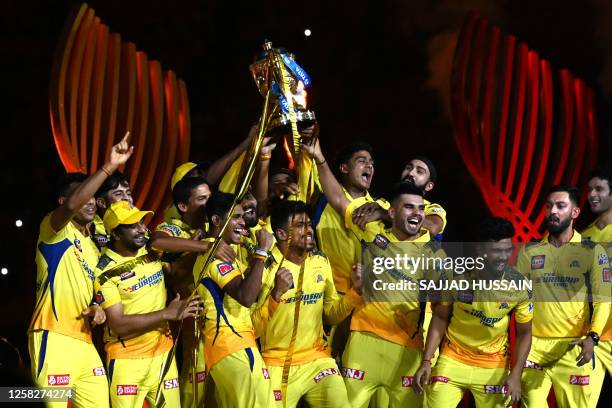 Chennai Super Kings' players celebrate with the trophy after their victory against Gujarat Titans in the Indian Premier League Twenty20 final cricket...