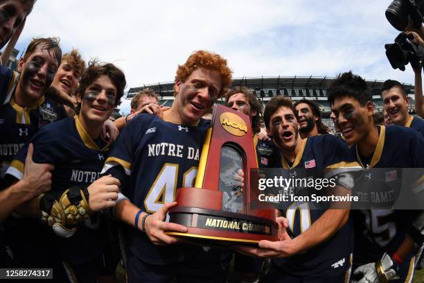 Notre Dame Fighting Irish players celebrate with the trophy following the NCAA Division I Men's Lacrosse Championship game between the Duke Blue...