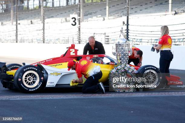 The crew of NTT IndyCar series driver Josef Newgarden polishes his car on May 29 after Newgardew won the 107th running of the Indianapolis 500 at the...