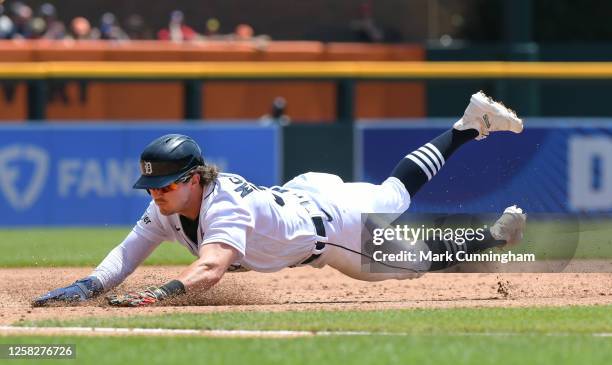 Zach McKinstry of the Detroit Tigers slides head-first into third base during the game against the Texas Rangers at Comerica Park on May 29, 2023 in...