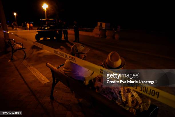 People are seen near a crime scene as law enforcement officers respond to a shooting at Hollywood Beach on May 29, 2023 in Hollywood, Florida. At...