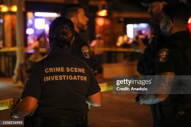 Hollywood Police officers investigate at the shooting scene after an altercation ended in gunfire at Hollywood Beach Broadwalk in Hollywood, Florida,...