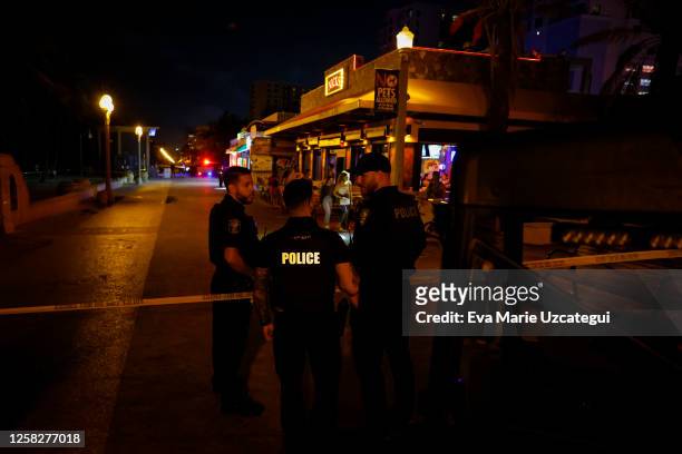 Law enforcement officers are seen on a crime scene as they respond to a shooting at Hollywood Beach on May 29, 2023 in Hollywood, Florida. At least...