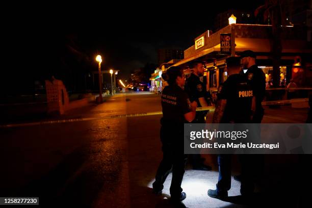 Law enforcement officers are seen on a crime scene as they respond to a shooting at Hollywood Beach on May 29, 2023 in Hollywood, Florida. At least...