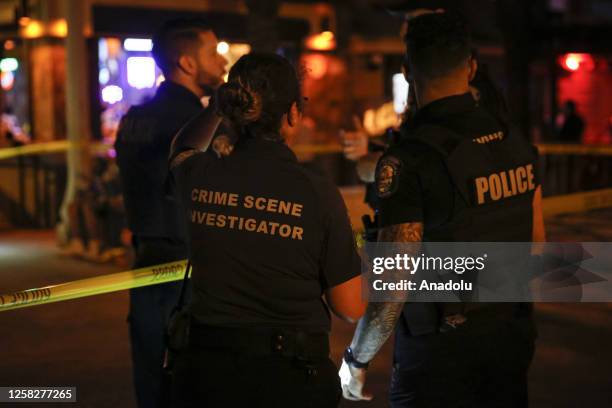 Hollywood Police officers investigate at the shooting scene after an altercation ended in gunfire at Hollywood Beach Broadwalk in Hollywood, Florida,...