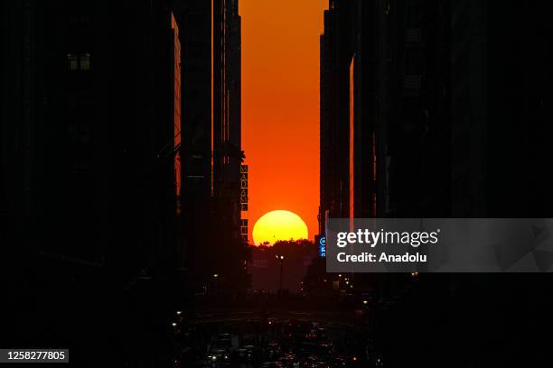 View of the sunset from 42nd street during the 'Manhattanhenge' on May 29, 2023 in New York, United States.