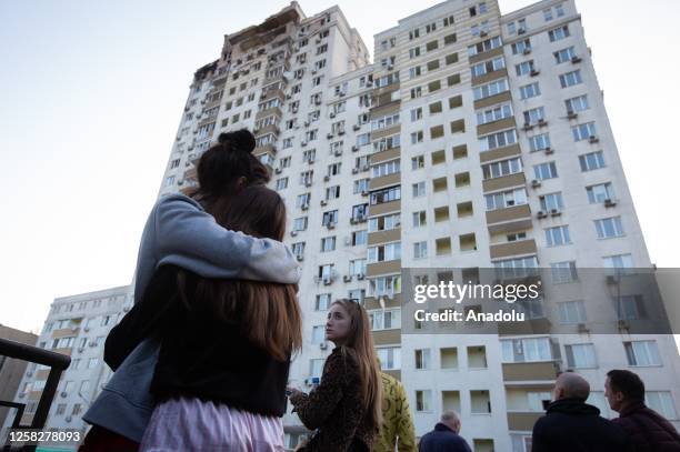 Woman embraces a girl near damaged residential building aftermath of nighttime drone attack in Kyiv, Ukraine amid Russia-Ukraine war on May 30, 2023.