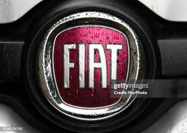 Fiat logo in the rain seen on a street in the city center on May 24, 2023 in Krakow, Poland.