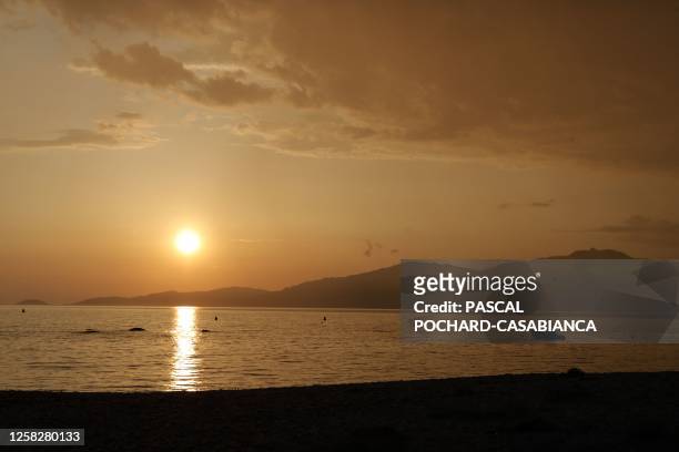 Sunset on Ajaccio city from Agosta beach in Albitreccia on the French Mediterranean island of Corsica, on May 29, 2023.