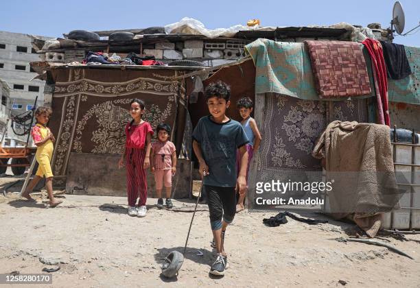 Children play in the street despite the lack of playgrounds in their neighborhoods under difficult conditions in Al-Zaytun district of Gaza City,...