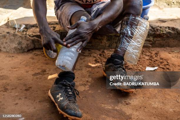 Ugandan baseball player Dennis Kasumba who dreams of becoming Uganda's first US Major League Baseball player uses plastic bottles filled with water...
