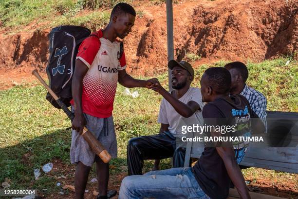 Ugandan baseball player Dennis Kasumba who dreams of becoming Uganda's first US Major League Baseball player greets baseball fans at the baseball...