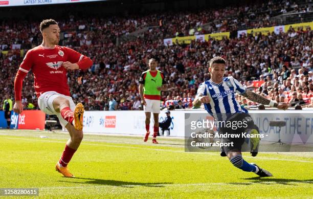 Sheffield Wednesday's Marvin Johnson crosses under pressure from Barnsley's Jordan Williams during the Sky Bet League One Play Off Final match...
