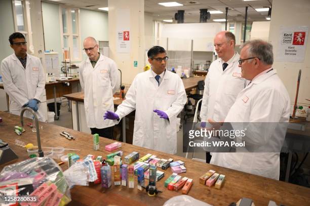 Britain's Prime Minister Rishi Sunak observes a test made on vaping products during a visit to Kent Scientific Services on May 30, 2023 in West...