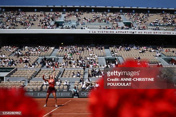 Italy's Lucia Bronzetti serves to Tunisia's Ons Jabeur during their women's singles match on day three of the Roland-Garros Open tennis tournament at...