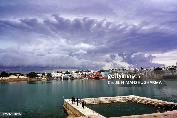Rain clouds hover over the holy lake Of Pushkar in India's desert state of Rajasthan on May 30, 2023.