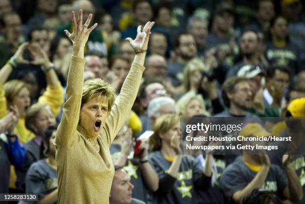 Baylor head coach Kim Mulkey celebrates as the Lady Bears open up a 20-point lead during the first half of a NCAA women's basketball game against...