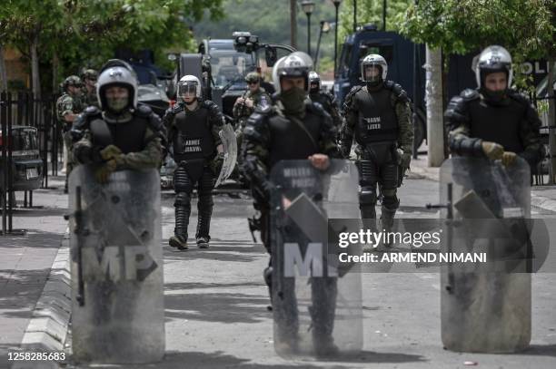 Soldiers and International military police secure the area near Zvecan, northern Kosovo on May 30 a day following clashes with Serb protesters...