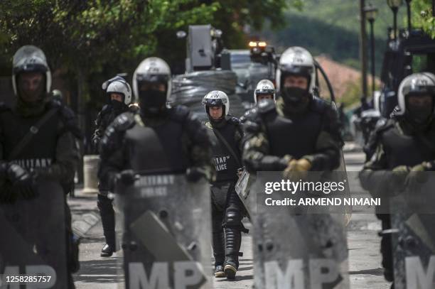 Soldiers and International military police secure the area near Zvecan, northern Kosovo on May 30 a day following clashes with Serb protesters...