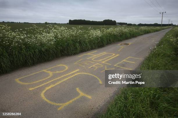 Huge pot hole in Murrow Lane has been marked with a large warning message in yellow paint, saying 'Hole Very Big' on May 30, 2023 in Murrow, England.