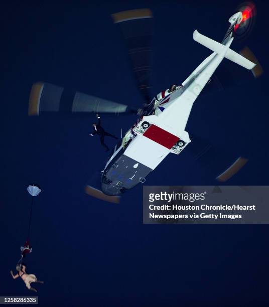 Performers depicting Queen Elizabeth and James Bond parachute from a helicopter during the opening ceremony for the 2012 London Olympics on Friday,...