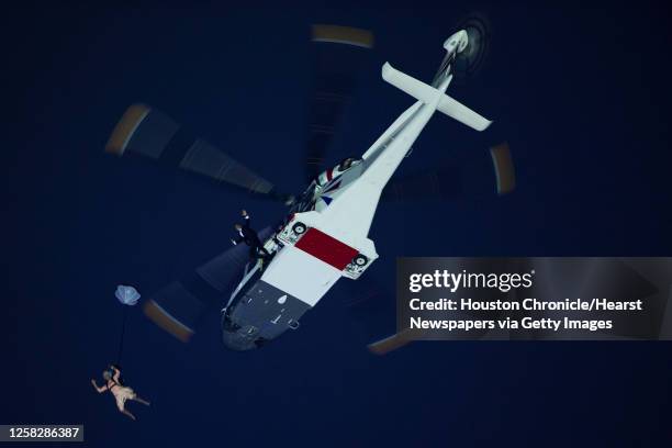 Performers depicting Queen Elizabeth and James Bond parachute from a helicopter during the opening ceremony for the 2012 London Olympics on Friday,...